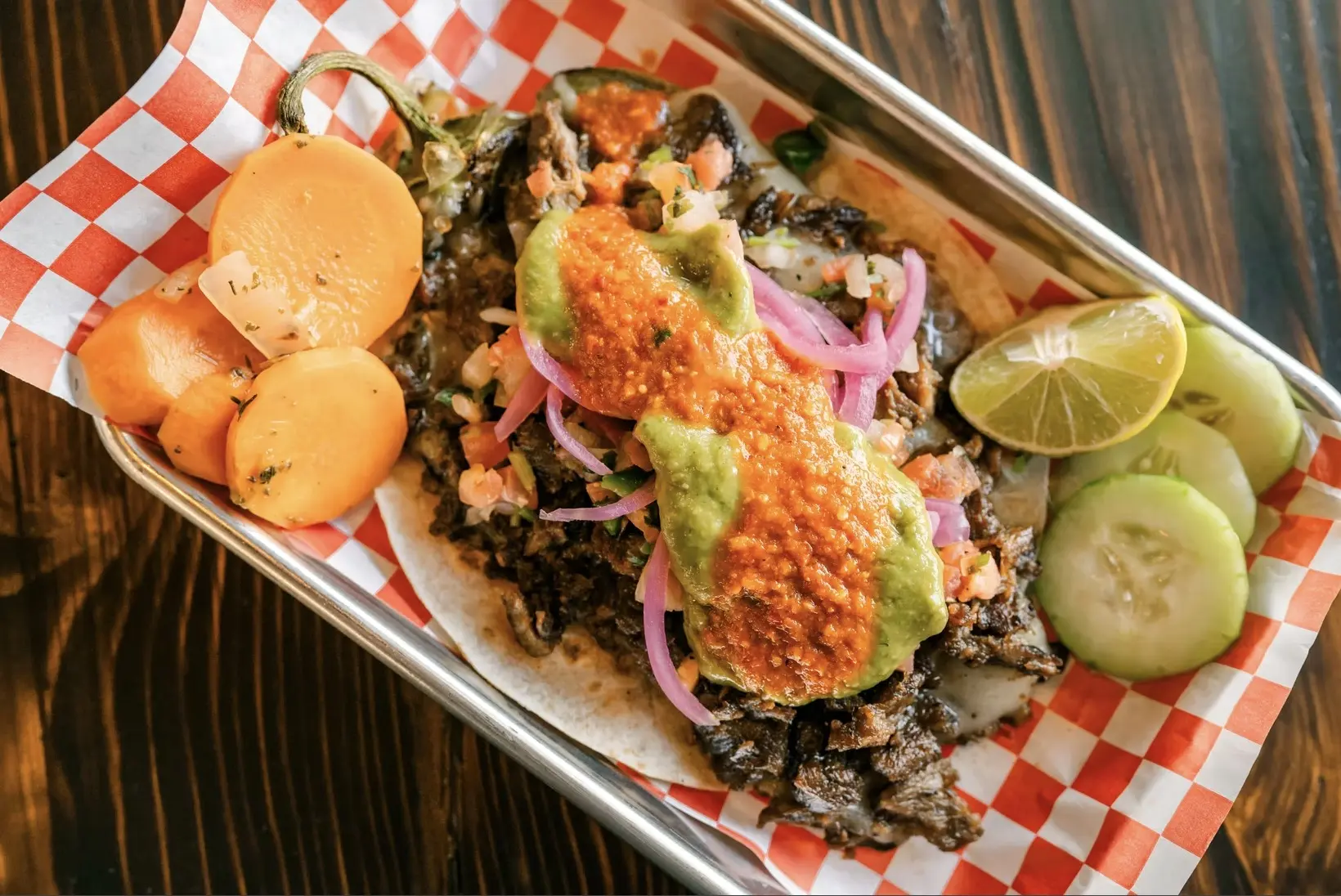 Loaded charcoal-grilled tacos at Carbon and Salt