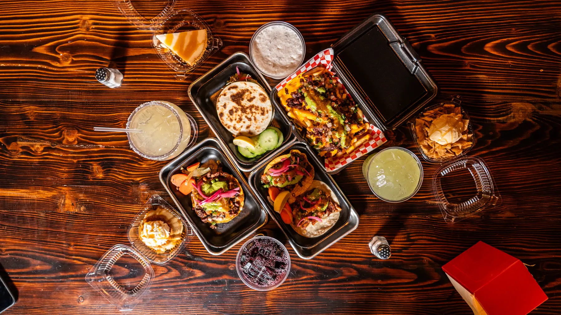 Overhead spread of Carbon and Salt tacos, drinks and sides