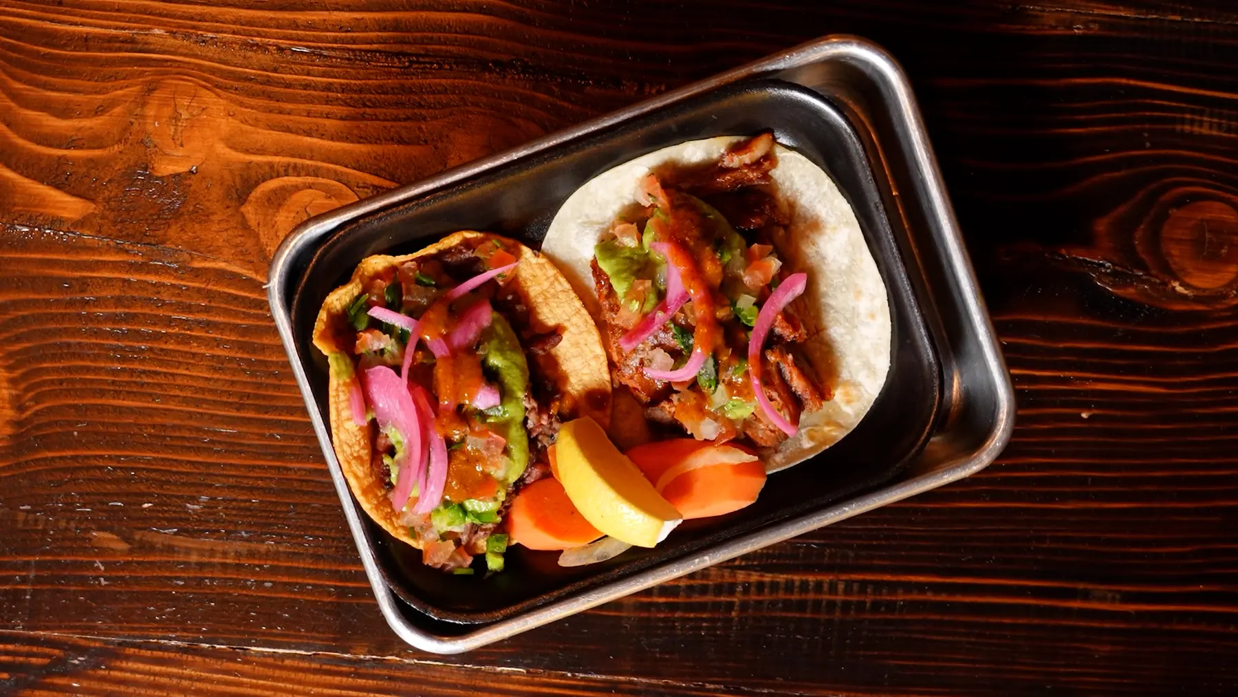 Two freshly prepared Mexican street tacos
